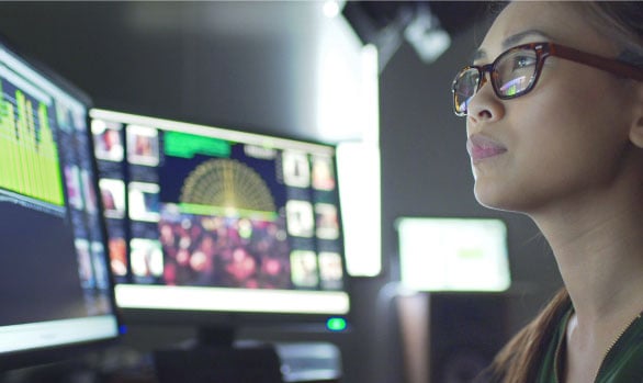 Woman monitoring incidents on computer screens