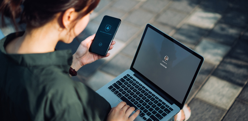 Worker with laptop authentication on mobile phone