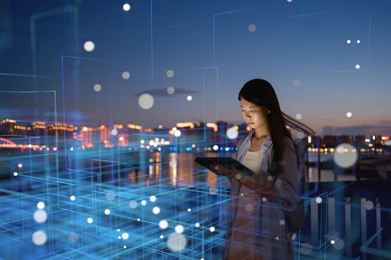 Woman with an iPad in a digital landscape